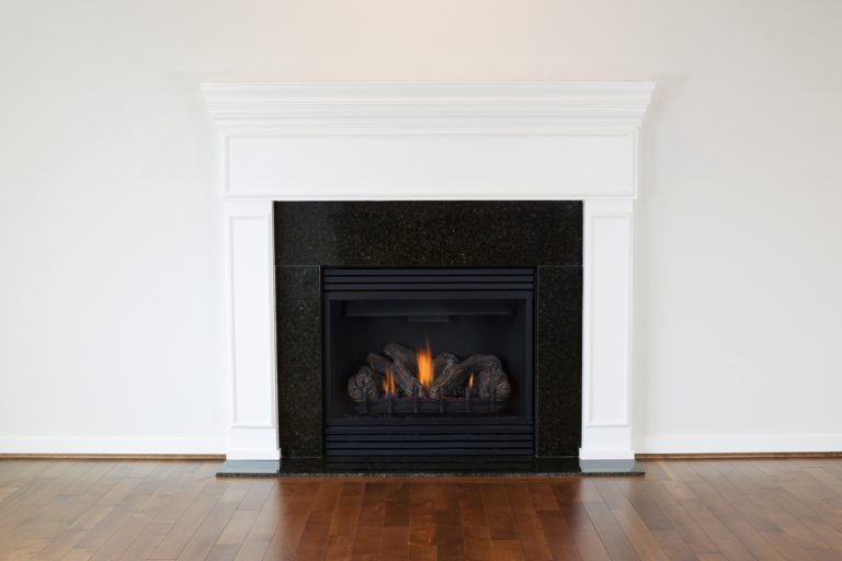 A gas fireplace with a white colored mantel, Should You Open the Flue on a Gas Fireplace?
