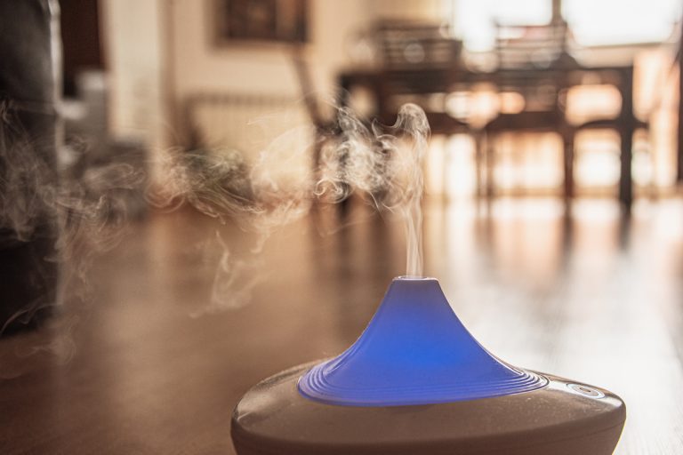 An Air Humidifier with placed on a wooden floor near the dining area, Should You Use A Humidifier In The Summer?