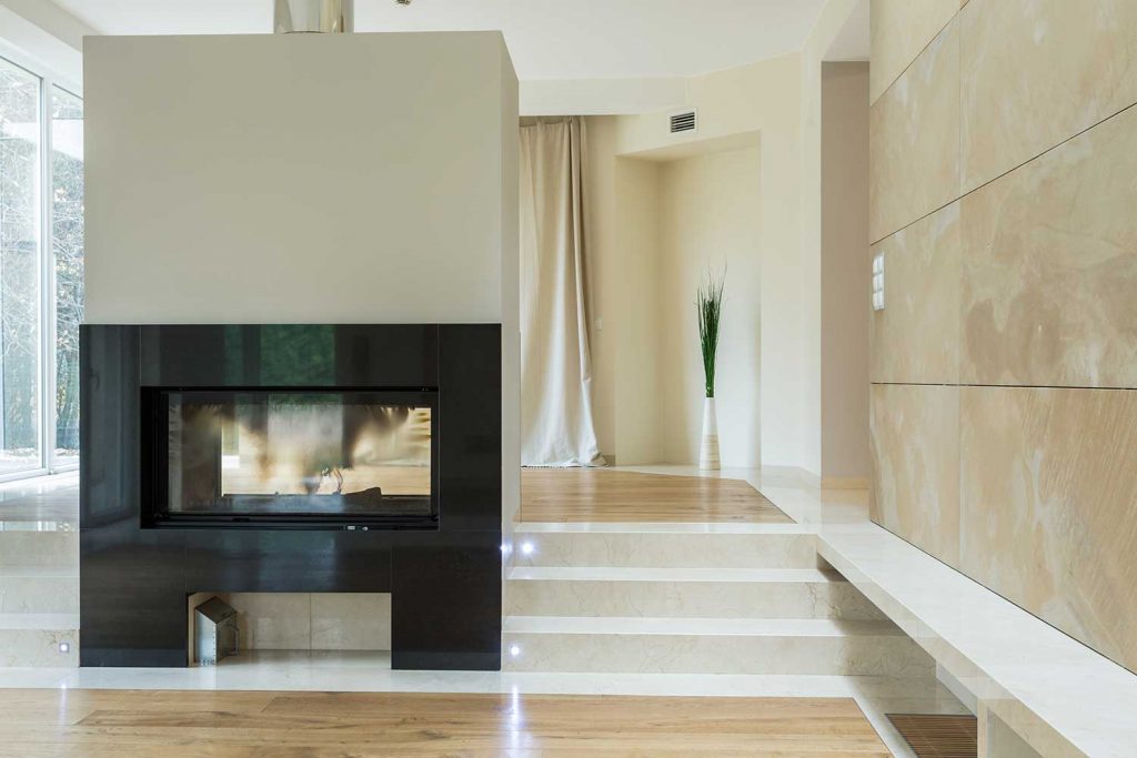 Close-up of fireplace in bright luxury mansion
