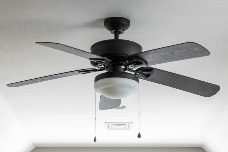 New construction house with a dark wood ceiling fan, How Many Blades Are Best On A Ceiling Fan?