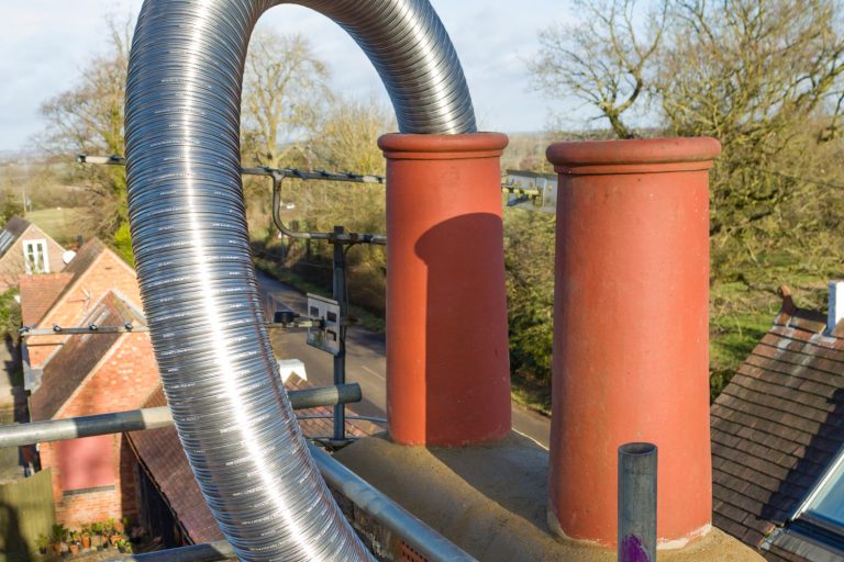 Installing a flexible steel flue liner into a chimney, 3 Types Of Chimney Liners - Which One Is The Best?