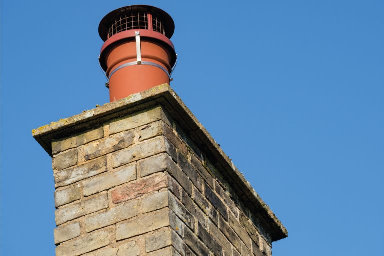 Brick chimney with red chimney cap, 8 Types Of Chimney Caps