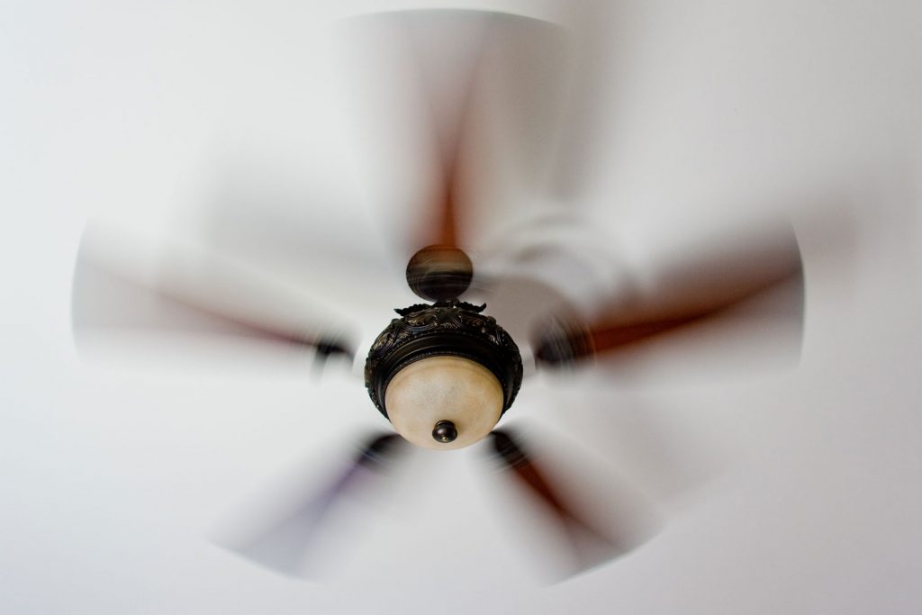 A ceiling fan spinning fast