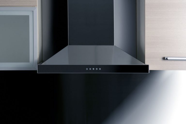 A modern auto cleaning kitchen range inside a contemporary kitchen, Which Kitchen Chimney Is Best: Auto-Clean Or Manual?