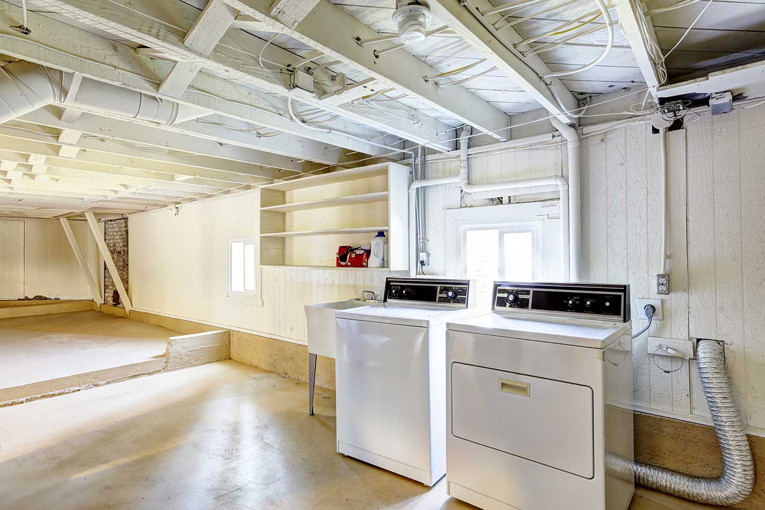 Empty basement in American house with laundry