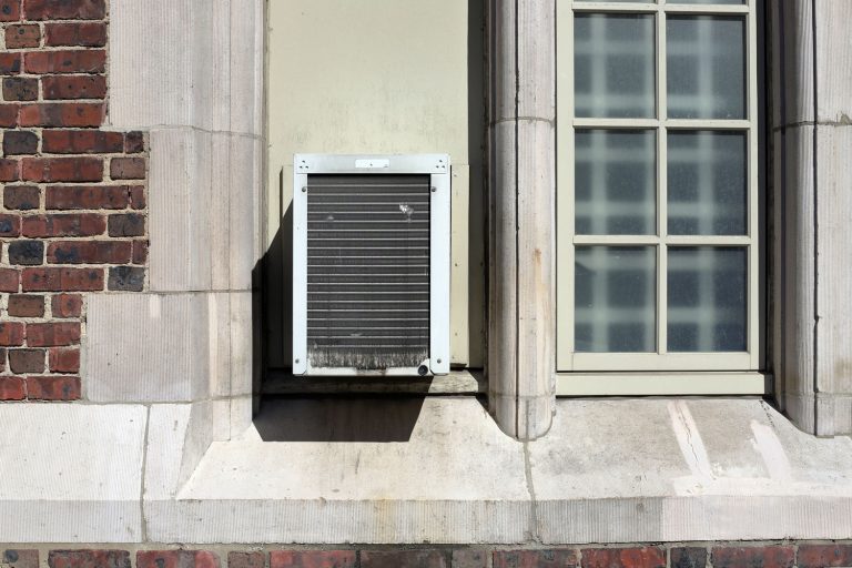A window air conditioner installed outside an apartment, Should A Window Air Conditioner Be Tilted?