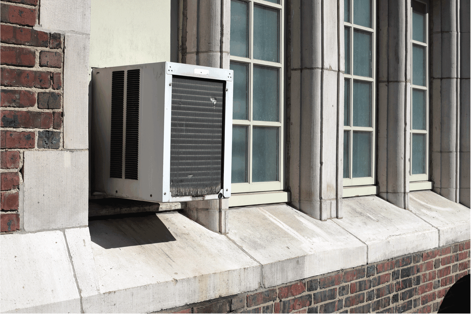 Window Air Conditioner unit on old brick building