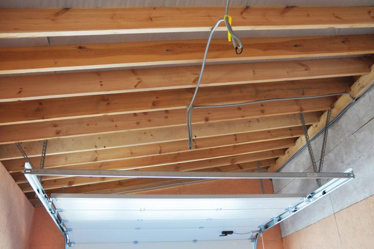 Exposed rafter ceiling of a small narrow wooden garage, How To Insulate Garage Ceiling Rafters