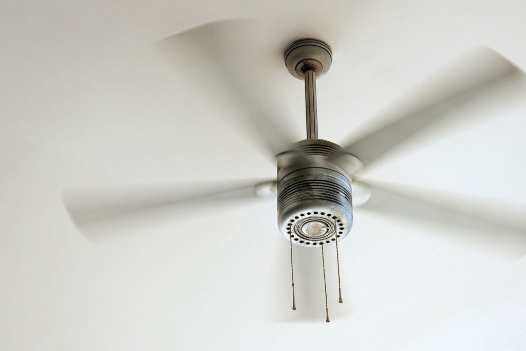 A ceiling fan inside a bedroom