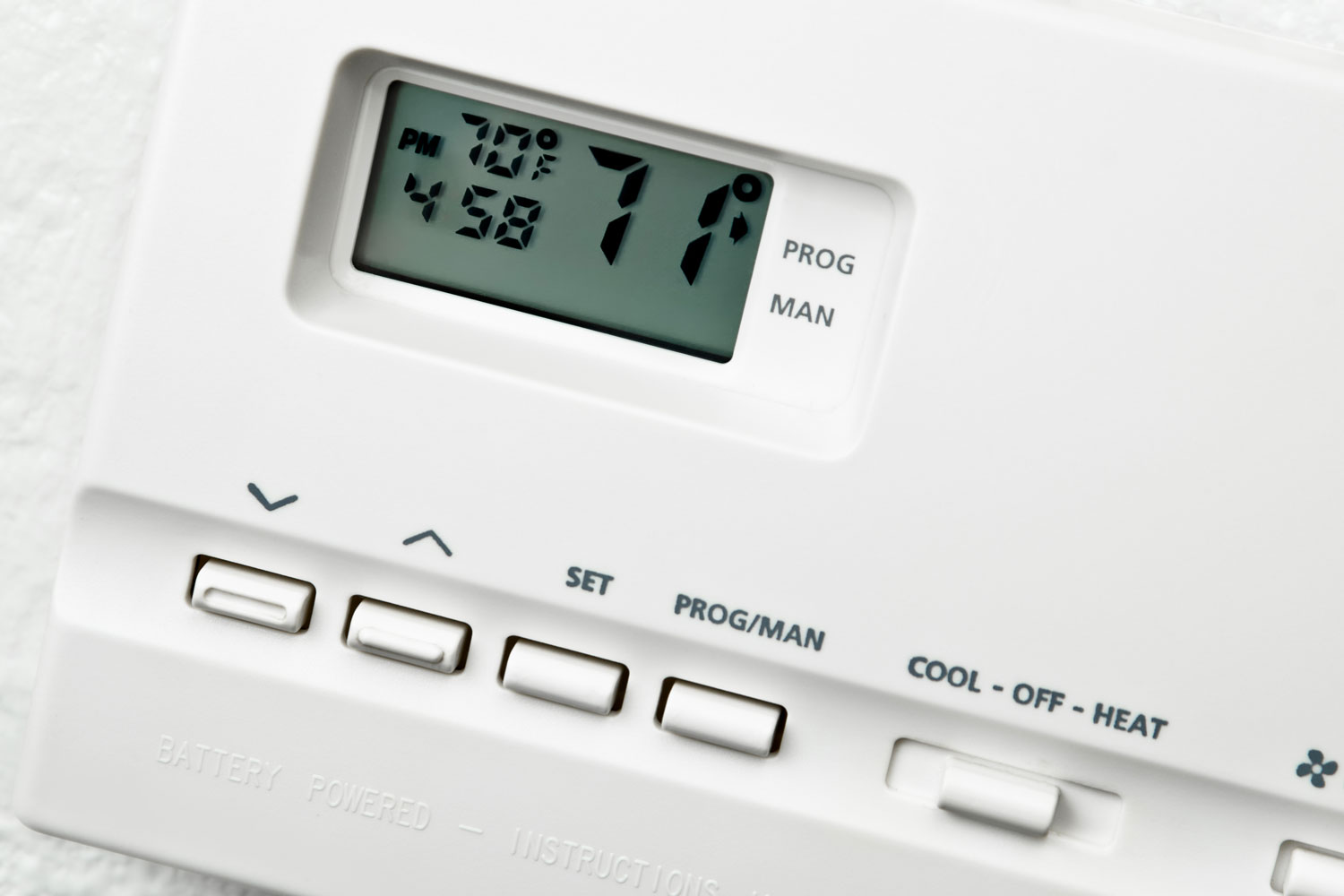 A digital thermostat indicating 71 degrees in the display