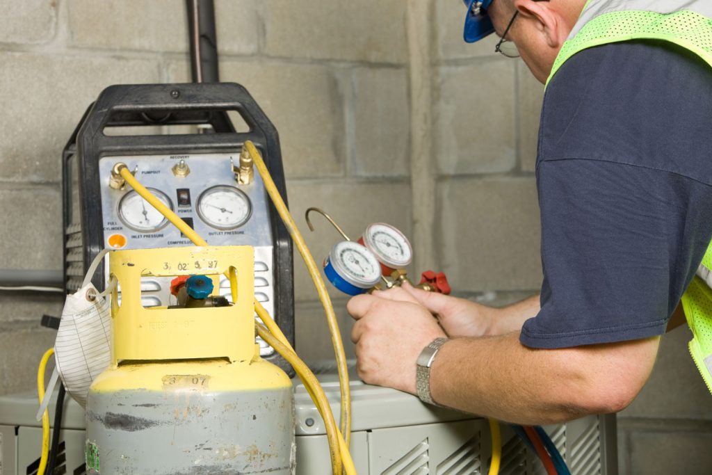 An Hvac personnel checking the refrigerant air conditioning system