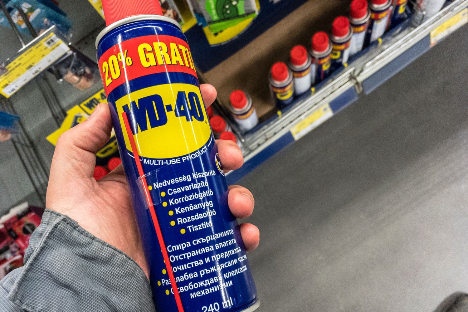 A man holding a WD-40 product on his hand