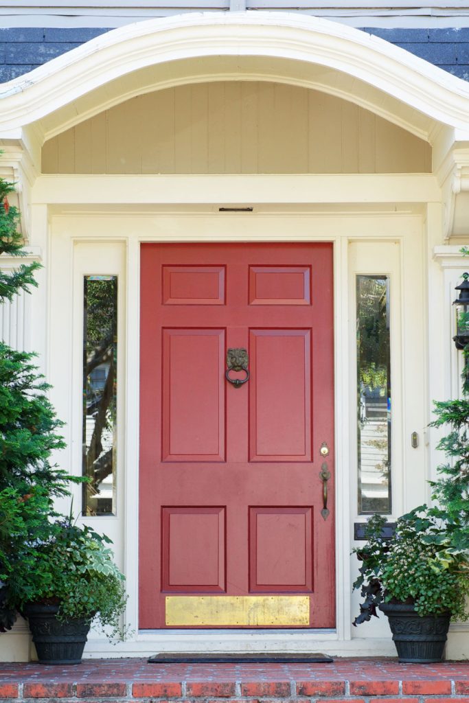 A red front door of a classic country home