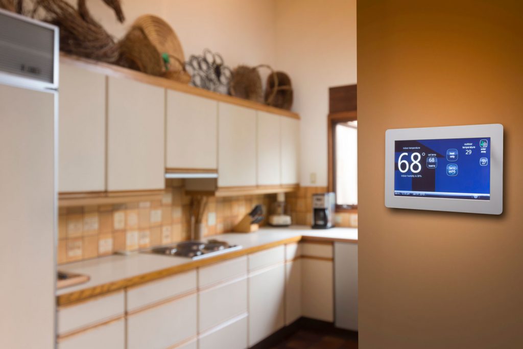 A thermostat set to 68 degrees for the kitchen area