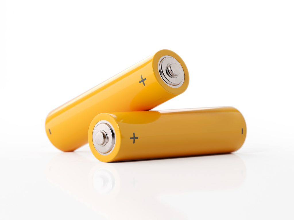 AA size two yellow batteries on white background. Horizontal composition with copy space.