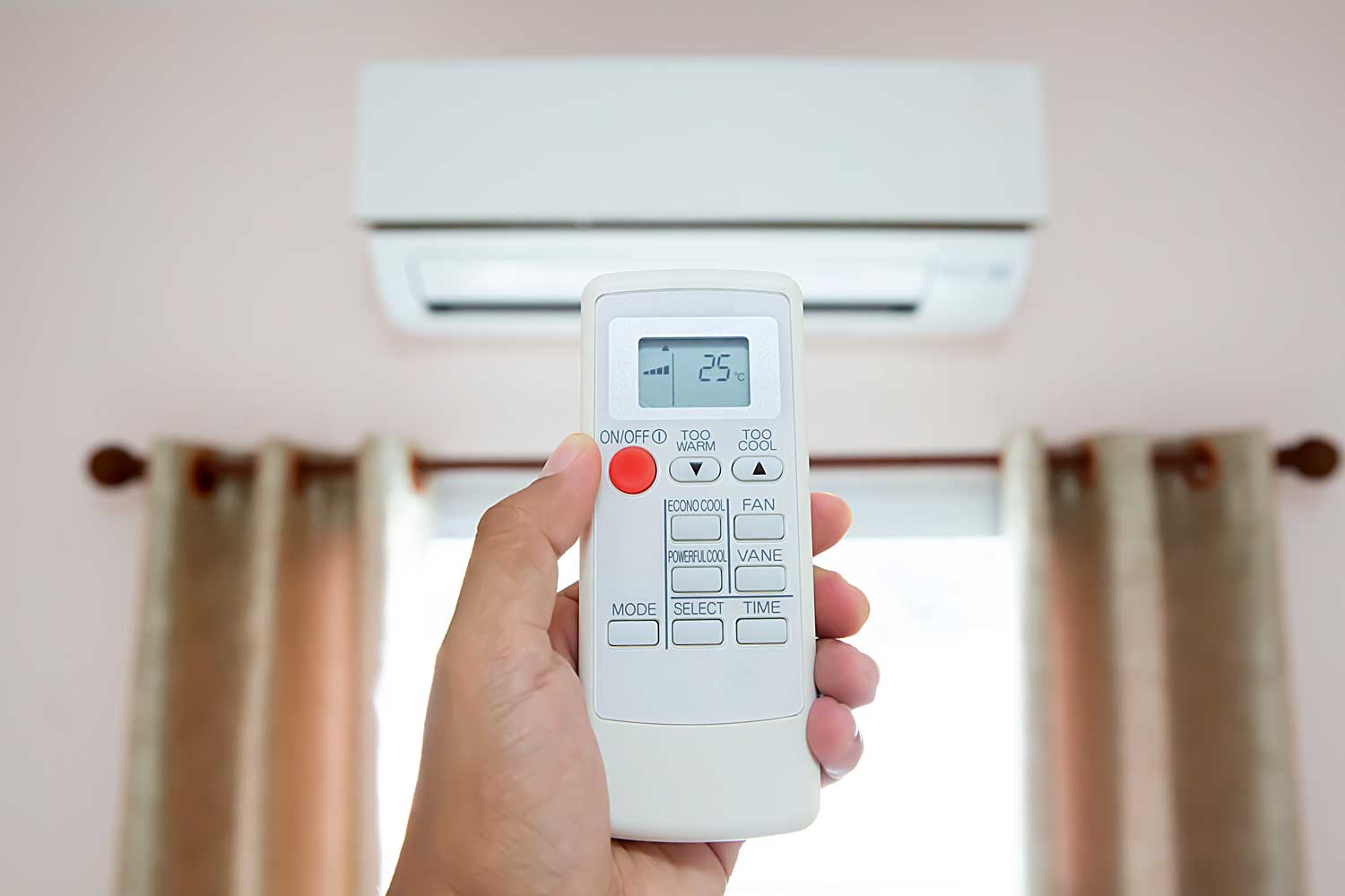 A hand using remote control open the air conditioner, AC Thermostat Keeps Shutting Off — What To Do?
