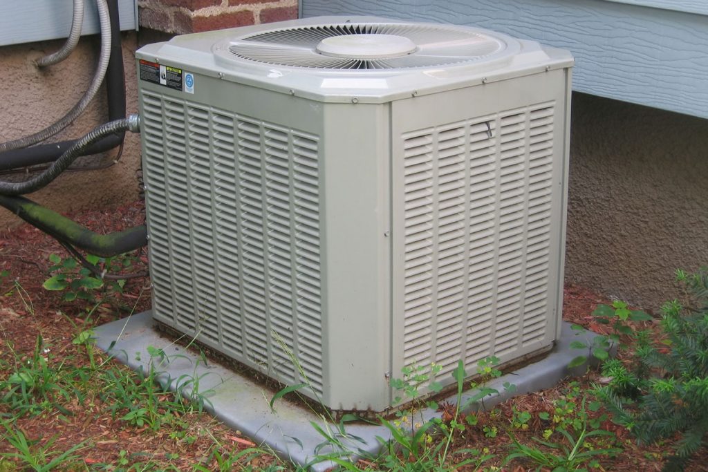 An air conditioning condenser unit outside a building
