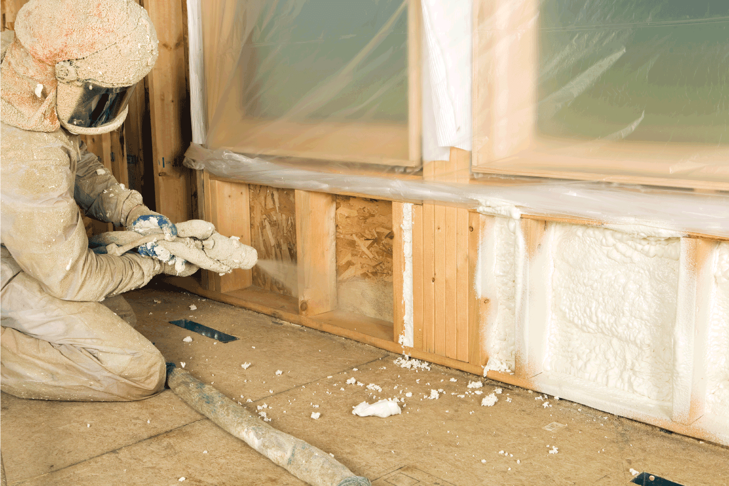 Construction Worker Spraying Expandable Foam Insulation between Wall Studs. Does Cellulose Insulation Deter Mice And Other Pests