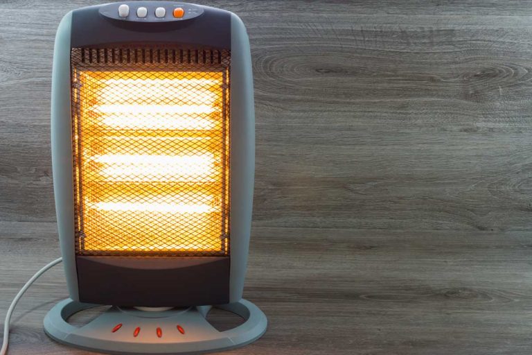 Electric heater radiating on gray wooden background, 5 Best Heaters For Car Camping