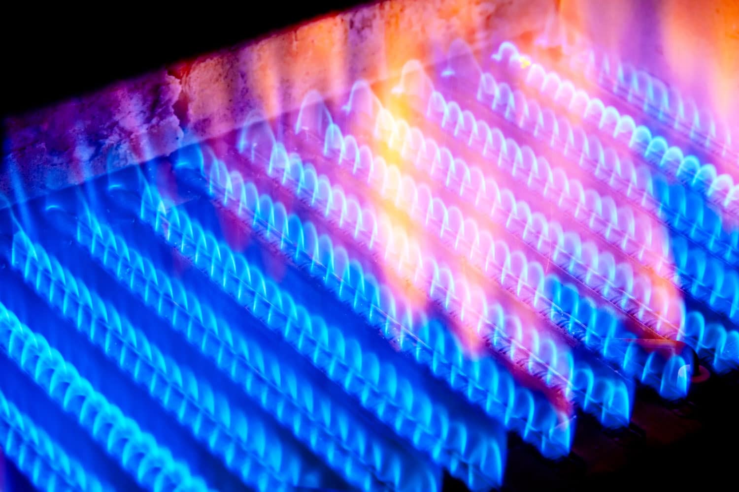 Fire burns from a gas burner inside the boiler