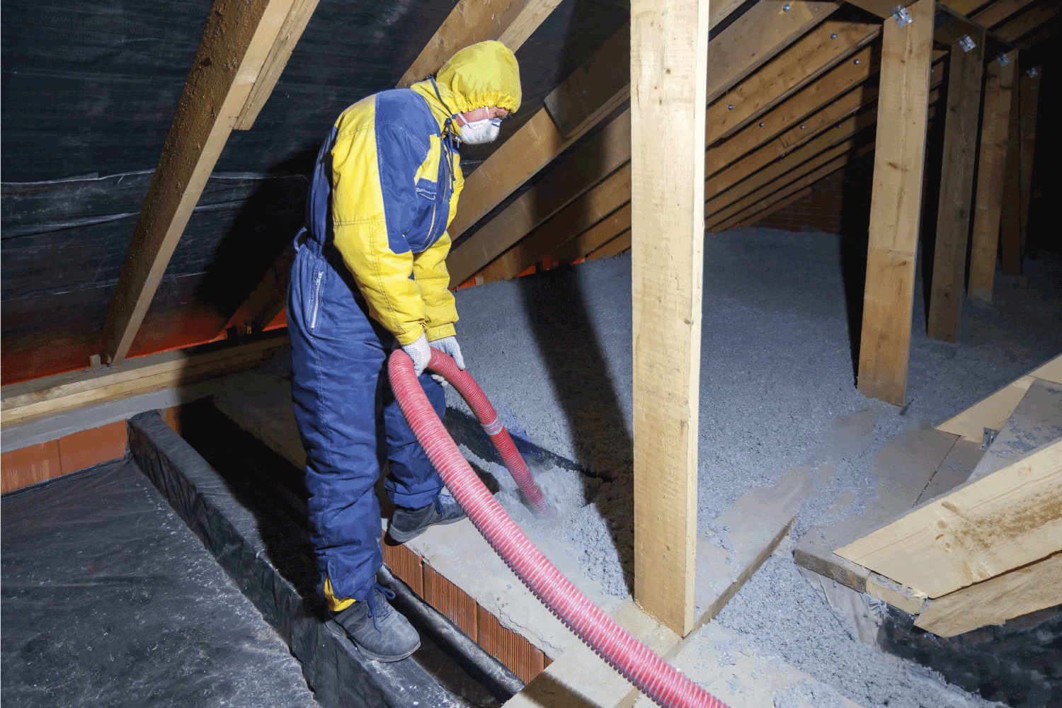 Insulation of the attic with cellulose insulation. Spraying from a hose