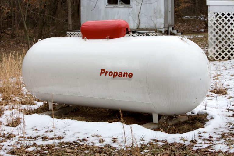 Propane Tank Outside Residence in Snowy Winter, How To Convert An Oil Furnace To Gas Or Propane—And Should You?