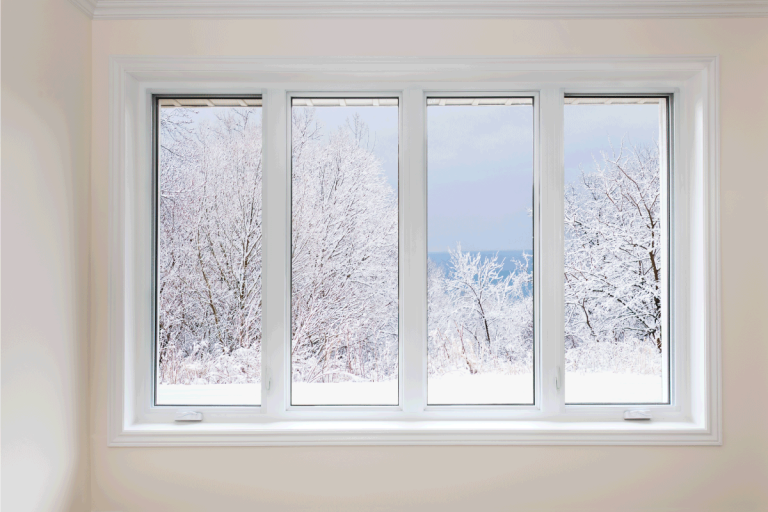 Window with view of winter trees. How To Insulate New Construction Windows