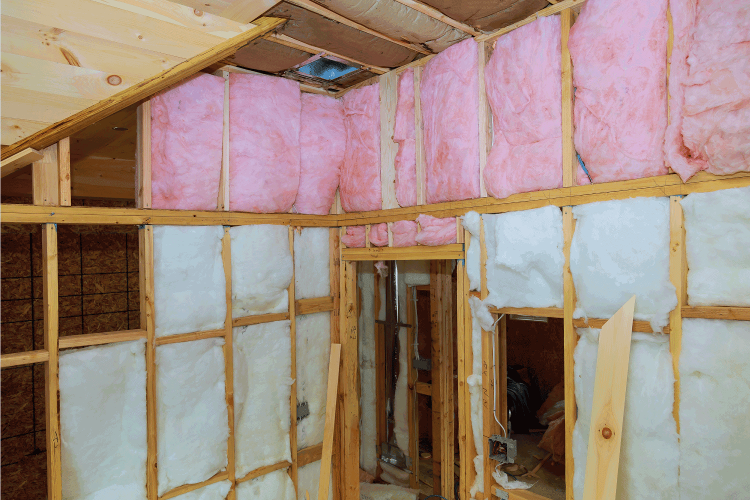 Wooden frame for future walls insulated with rock wool and fiberglass insulation