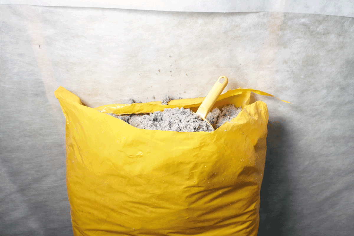 The ecologicaly clean cellulose insulation, insulation from recycled newsprint in a yellow sack with mini shovel. Does Cellulose Insulation Decompose Or Deteriorate