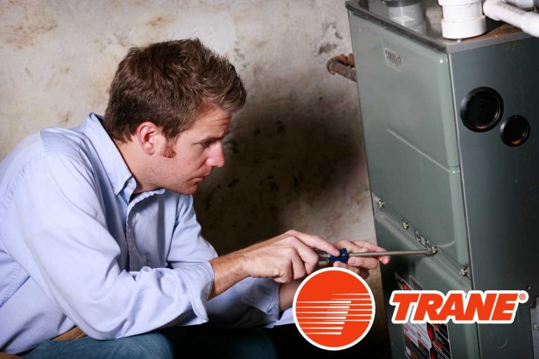 Service man working on furnace, How To Reset A Trane Electric Furnace