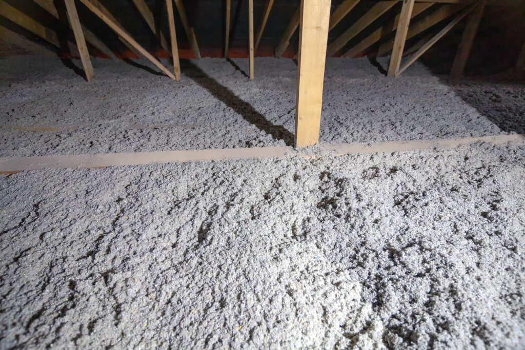 Eco-friendly cellulose insulation sprayed on the attic roofing