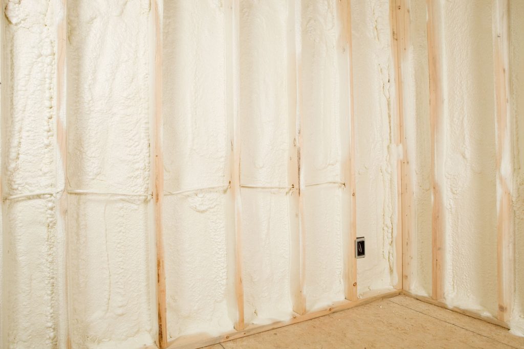 Foam insulation in between the wooden framing of the walls of a house