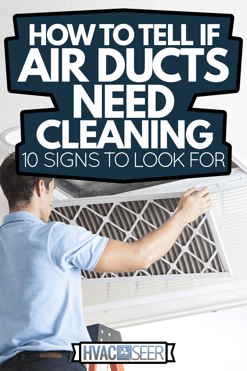 Man cleaning air ducts in home, How To Tell If Air Ducts Need Cleaning—10 Signs To Look For