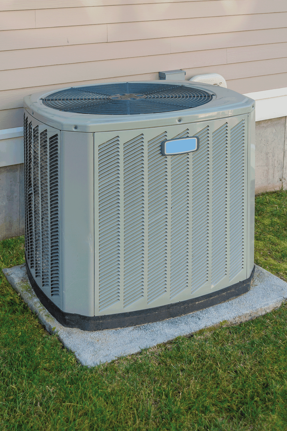 home heating and cooling unit beside the house