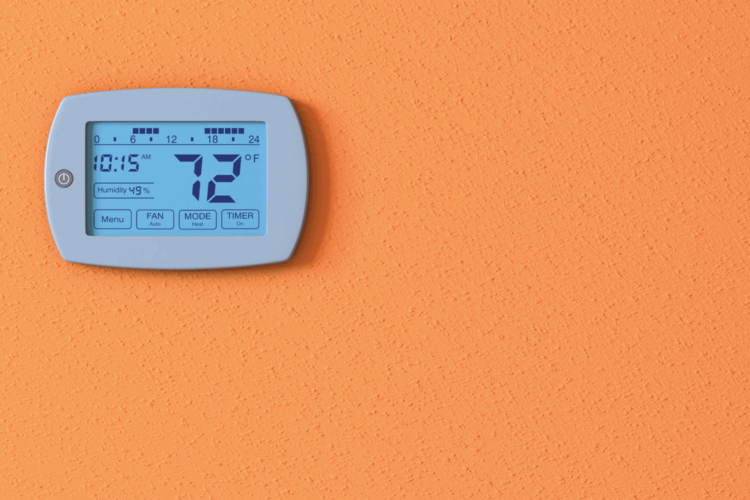 home thermostat panel on an orange wall