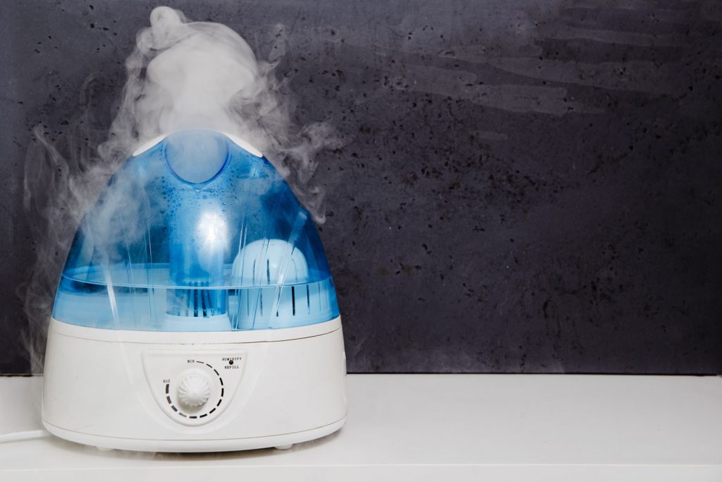 A blue humidifier on top of a table