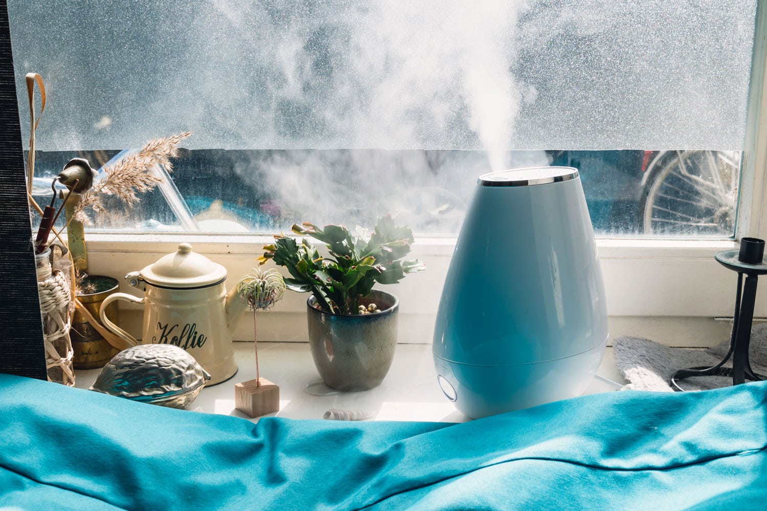 A blue humidifier placed near the window