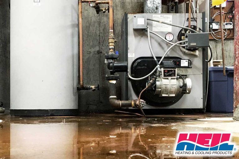 A burst pipe at the furnace and water tank caused a leak on the basement floor of a house, Heil Furnace Leaking Water - What To Do?