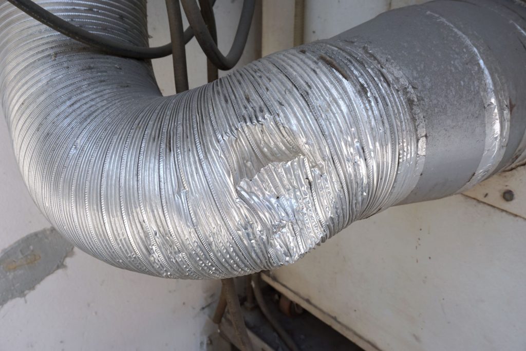 A dented furnace exhaust vent