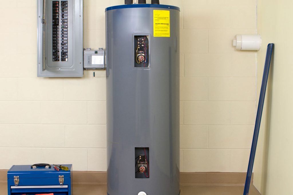 A residential water heater in the basement of a tan colored wall