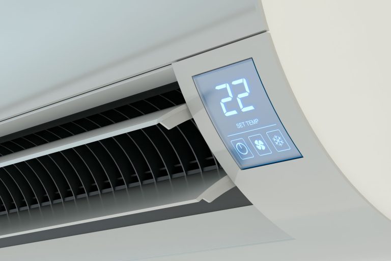 An air conditioning unit inside the living room set at 22 degrees Fahrenheit, Should You Turn Off Air Conditioner When Not Home?