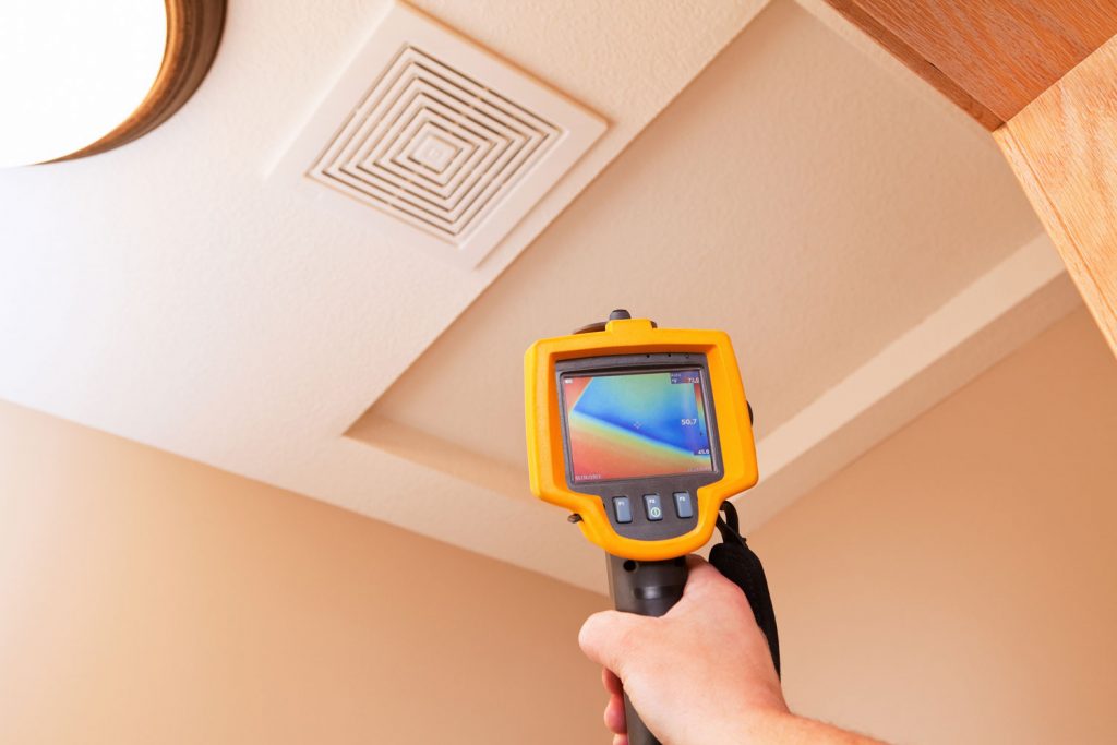 An infrared thermal imaging system being used during a home energy audit