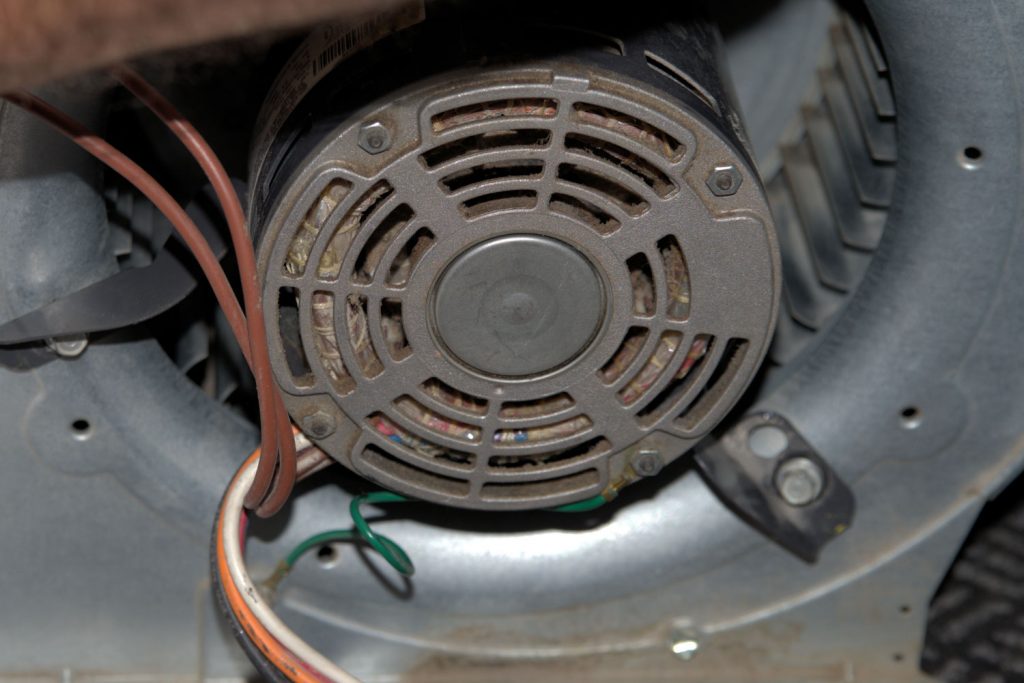 An up close photo of a furnace fan motor