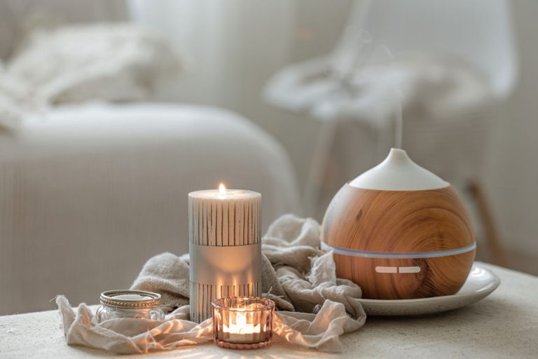 Cozy home composition with air humidifier and candles on blurred background, Do Humidifiers Turn Off Automatically?