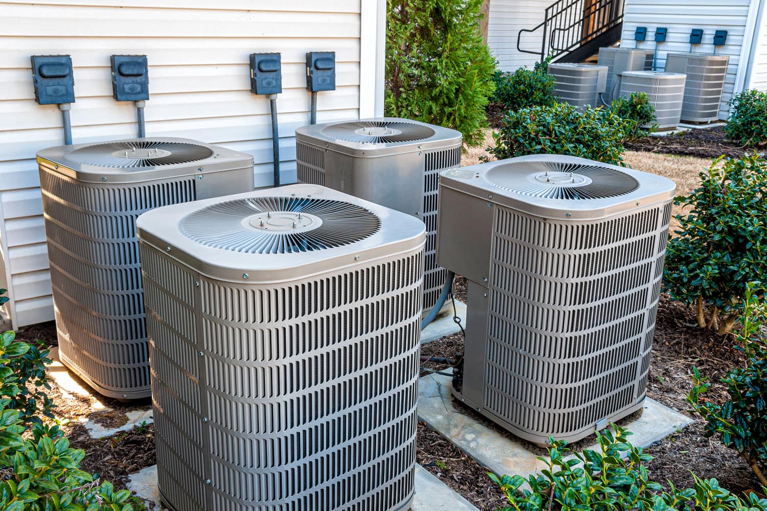 Four air conditioning condenser units placed outside