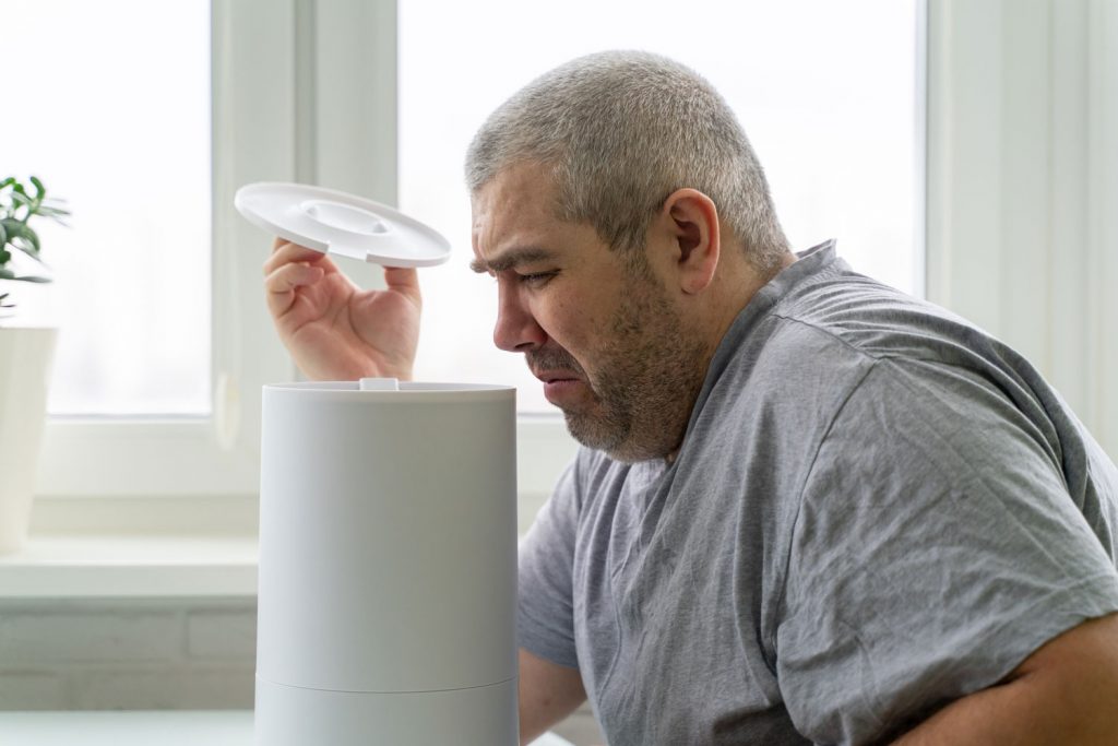 the humidifier smells bad. the man doesn't like the smell from the humidifier.