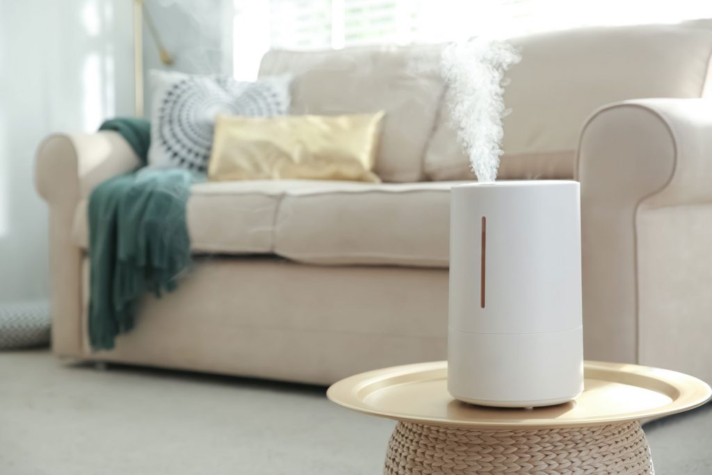 Modern air humidifier, aroma oil diffuser at home