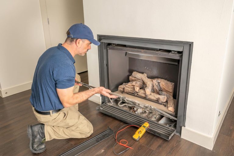 Service technician repairing a gas fireplace in a home, Gas Fireplace Won't Start - What To Do?