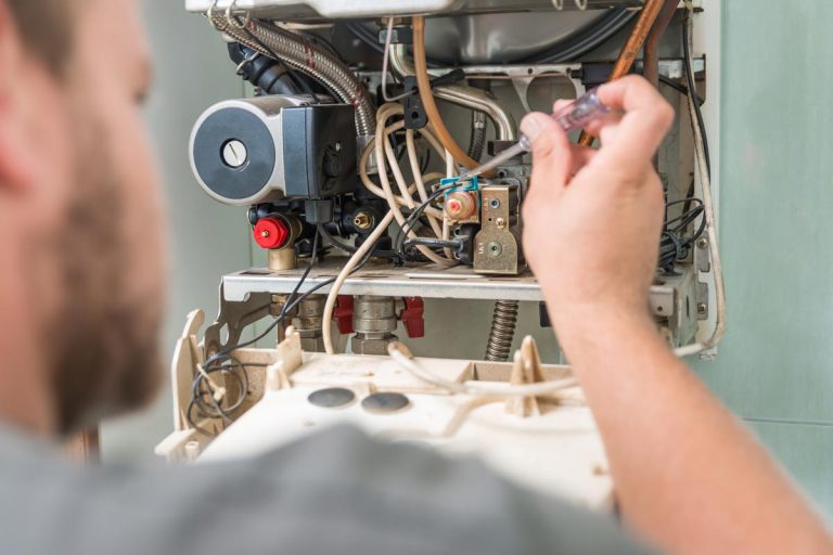 Technician repairing furnace, Furnace Won't Turn On After Summer - What Could Be Wrong?