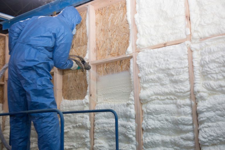 The worker insulates the walls of the house with foam for sound insulation and heat, Does Spray Foam Insulation Cause Moisture Problems?
